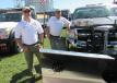 Cory Walters (L) and Erich Rose, both of KE Rose Company, stand with this Fisher Engineering snowplow.

