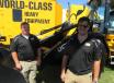 Brandon Hawkins (L) and Bruce Mustard of JCB  show attendees equipment, including this JCB 427 agri wheel loader.
