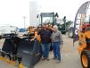 Travis Lindekugel (L), sales manager of GrabTech Manufacturing, Larchwood, Iowa, stands with Harold Watnemo, Titan Machinery field marketer, Fargo, N.D., and a Case 521FXR wheel loader.   
