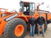Chris Landis (L), sales specialist, Ironhide Equipment, Grand Forks, N.D., and Nathan Cain, Doosan Infracore product trainer, Fargo, N.D., stand with a Doosan DL300 loader.      
