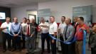 Robert Mann (front holding scissors), DEUTZ Corporation president and CEO and Michael Wellenzohn (back holding scissors), a member of the DEUTZ AG board of management with responsibility for sales, service and marketing, cut the ribbon at the event. 