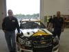 Darrell Hughes (L) and Jerry Hemmerling, both of the village of Mundelein, get a closer look at the Cat race car driven by NASCAR driver Ryan Newman.
