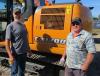 Dave Horst (L) and Marvin Edwards of Crooked Oak Farms consider bidding on this Case CX130D excavator.
 