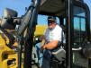 Rick Hooser of Ridgeline Equipment who came in from Barboursville, W. Va., checks out this Caterpillar 308 excavator at the auction.
 