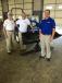 (L-R): Bob and Tim Cockerham of Charlotte Tractor talk with Ben Demanee, New Holland Territory business manager. 