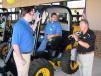 Larry Ashley (R) of JCB points out the safety features of the JCB 260 skid steer loader to Mark Reida (L) and Dana Goodman, staffers of Cobb County, Ga. 