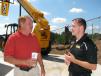 Anthony Bentley (L) of Marietta, Ga., and Pete Gallagher, JCB backhoe sales manager, Savannah, Ga., talk about the machines on display.  