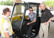(L-R): Zack Kerns of Kennesaw State University Sports & Entertainment Park, Kennesaw, Ga., and David Bennet of the Kennesaw State University events staff, Kennesaw, Ga., receive more information about a JCB telehandler from Ken McGuffin, Atlanta JCB. 