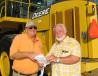 Bob Hoggle (R), JM Wood Auction Company Inc., greets and talks with Buddy Jones, Pat Jones Construction, Tuscaloosa, Ala., about a pair of 844K Deere wheel loaders about to go on the auction block. 
 