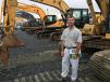 Scott Tulloss of Tullos Equipment Company in Rocky Mount, N.C., looks over the Cat, Hyundai and John Deere excavators.
 