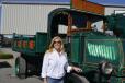 Tracy Saunders, president of W.F. Saunders, stands proudly with her 1925 Mack truck that has remained in the W.F. Saunders fleet all these years. 