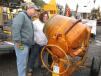 Robert Lodge and Cynthia Eisnor of Lodge Earth Works of Windsor, Conn., look at a cement mixer, which they considered for purchase.
 