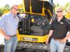 Andrew Presswood (L), Presswood Construction, Cleveland, Tenn., and David Barker, JCB retail sales manager, based in Atlanta, Ga., inspect the engine of this JCB 100 C-1 mini-excavator. 