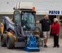Mother and son, Rebecca (R) and Jeff Llewellyn, stand beside the Volvo MC115C skid steer loader.
