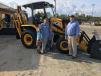 Neil Williams (R) of Company Wrench goes over the JCB 3CX backhoe with George, Katie and Cana Wilson of Wilson Farm in Kershaw, S.C.
