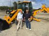 Ken Hanna (R), Hanna Farms in Lake City, S.C., currently owns a JCB backhoe and asks Billy Wall of Company Wrench about other items in the JCB product line. 
