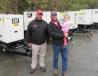 Mike Jones (L) of Cleveland Brothers walked A.J. Brentzel  of A.J. Brentzel  Excavation & Services and Brentzel’s daughter, Blaire, through the lineup of equipment on sale. 