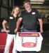 Amanda Hague, Yancey Bros. Co., presents another prize winner, Charles Waters of the city of Roswell, Ga., with a Grizzly cooler packed with goodies. 