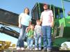 (L-R):?Chasity, Weston, Brayden and Donavon Windham, independent contractor, based in Bay Springs, Miss., look over the forestry equipment, including this John Deere 437D knuckleboom log loader. 
