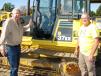 Darrell Harp (L) and Dewey Garner, both of Darrell Harp Enterprises, a manufacturer-distributor of a wide variety of 3-point hitch equipment, Red Bay, Ala., shop the selection of dozers, including this Komatsu D37EX.     
