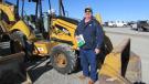 Jeff Isom of the Roper Corporation in Odessa, Texas, plans to win the bid on this Cat 420E backhoe. 
