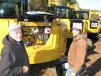 Jerry (L) and Logan Turner, both of Dog River Grading, Carrollton, Ga., look over a trio of new 2016 Cat 308e2 CR mini-excavators.    
