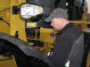 Steve Nethery of Artec Tractor & Equipment, Nauvoo, Ala., completes an inspection of the center articulation point of a Cat wheel loader.
