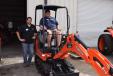 Kevin Edling (L), sales representative of Florida Coast Equipment, and Aaron Tull of Tall Oaks, Naples, Fla., test this new Kubota mini-excavator KX 018-4