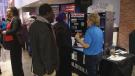 Visitors to the job fair discuss taking on a trade skill with a booth representative. (WSYX/WTTE)