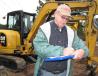 Billy Sibley, Sibley Equipment Company, Woodstock, Ala., takes a few notes on the equipment. 