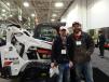Chris Korfiatis (L), president of Groundwrx, Maple Grove, Minn., and Jesse Eastman of AB Landscape, Zimmerman, Minn., check out this Bobcat T595 at the Tri-State Bobcat, Burnsville, Minn., booth. 
 