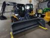 This popular John Deere 320E skid steer comes with an MTS 8 ft. (2.4 m) pusher plow snow removal package.  