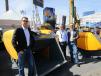 Hartl Crusher North America brought its line of crusher buckets to ConExpo. (L-R): Martin Hartl, vice president; Alexander Hartl, CEO; and Dominic Hartl, president, pose for a photo around their HBC1250 model.
