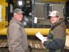 Steve Gross (L) and Justin Smedley of Gross Farms, Gadsden, Ala., get a better look inside this John Deere 290G excavator. 