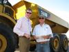 Bobby Lee Phillips (L) and Blake Hill, both of Phillips Contracting Co., Columbus, Miss., compare notes on this Cat 740B artic dump truck.  