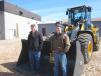 Ryan Burkholder (L) and Elvin Zimmerman, both of Burkholder Tractor, inspect this John Deere certified used 544K wheel loader.  