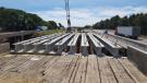Crews install new girders for I-39/90 bridge over local roadway.