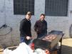 Eric Grube (L), Bobcat district service manager, mans the grill with Tim Krahn, senior manager, dealer accounts, Bobcat Company, West Fargo, N.D. 