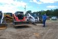 Adam (L) and Dennis Warren of Arkansas get a closer look at the selection of skid steers. 