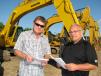 Vance Terry (L) and Bryan Boyd, both of Gunter Construction, Lawrenceville, Ga., check  out the excavators.   