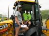 Doug White of East Fallowfield Township and his daughter, Jillian, demo a brand new JCB model 3CX backhoe similar to the one they have back home.