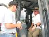 Checking out the cab of a John Deere 650K dozer in the sale lineup is Hugh (L) and Rush Cameron of Cameron’s Quail Preserve, Aliceville, Ala 
