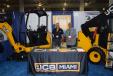 Elio Leon (L) and Kenneth Lemus, both of JCB Miami, discuss the JCB 8018 CTS mini-excavator and the  JCB 190 skid steer.
