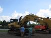 George Nogueiras, sales manager, Newark Equipment Sales Corp., inspects this Cat 330CL hydraulic excavator.