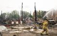  Firefighters from Whatcom County Fire District 7 work to put out remaining hot spots during a fire at Friberg Construction on Saturday, June 17, in Ferndale.
(Evan Abell photo)

