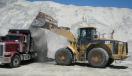 A Cat 980G wheel loader is used for loading trucks with aggregate.