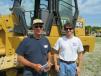 John (L) and Dave Hadam, both of Granger Tractor & Parts Inc., look for bargains at the auction.  