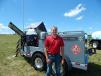 Derek Shalla, equipment sales representative, Stutsman Equipment Sales, Hills, Iowa, stands with the Thunder Creek FST 990 fuel, service and lubrication trailer. 
