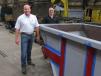 Donald A. Kruschke (L), president and CEO of both Loveman Steel & Fabrication and Plastics Machinery Group, joined Loveman Steel & Fabrication’s Chief Operating Officer Rob Campbell to inspect a new stone box being custom painted in Ohio State’s scarlet & gray.
