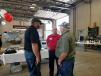 MMC representative Pat McBroom (C) discusses Screen Machine products with Travis and Rick Smith of Corsa Coal. 